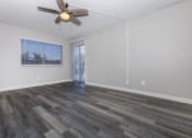 Thumbnail 5 of 22 - an empty living room with a ceiling fan and a window