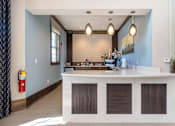 Thumbnail 12 of 29 - A reception area with a white counter and brown shades.