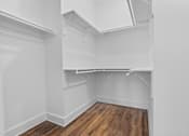 Thumbnail 25 of 33 - Empty room with white walls and wooden floor.