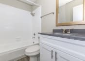 Thumbnail 8 of 20 - a bathroom with a sink and a toilet and a bath tub