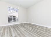Thumbnail 15 of 22 - a bedroom with hardwood floors and white walls
