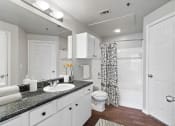 Thumbnail 8 of 32 - a bathroom with a sink and a toilet and a shower
