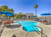 Thumbnail 17 of 20 - our resort style swimming pool is surrounded by patio furniture and umbrellas