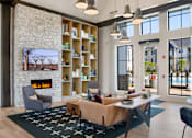 Thumbnail 17 of 47 - A living room with a fireplace and a large window.