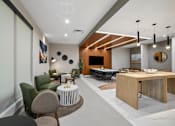 Thumbnail 19 of 26 - A modern living room with a large TV and a dining table.
