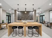 Thumbnail 17 of 26 - A modern dining room with a wooden table and black stools.