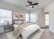 Thumbnail 29 of 65 - an empty bedroom with a bed and a ceiling fan