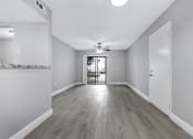 Thumbnail 5 of 33 - an empty living room with white walls and a ceiling fan