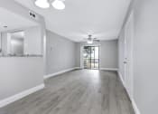 Thumbnail 4 of 33 - an empty living room with white walls and a ceiling fan