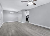 Thumbnail 6 of 33 - the living room of an empty house with a ceiling fan