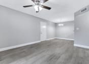 Thumbnail 7 of 33 - the living room of an empty house with a ceiling fan