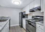 Thumbnail 1 of 33 - a kitchen with stainless steel appliances and white cabinets