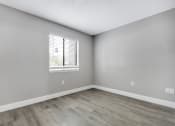 Thumbnail 9 of 33 - an empty room with wood floors and a window