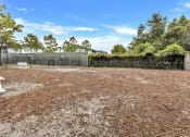 Thumbnail 27 of 33 - an empty yard with a fence and a bench