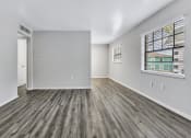 Thumbnail 4 of 29 - the living room of a new home with a large window and wood flooring