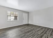 Thumbnail 5 of 29 - the living room of an apartment with wood flooring and a window