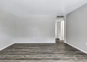Thumbnail 6 of 29 - an empty room with white walls and a wood floor