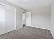 Thumbnail 9 of 29 - an empty bedroom with white walls and white doors