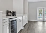 Thumbnail 14 of 29 - a kitchen with white cabinets and stainless steel appliances and a window
