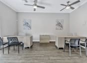 Thumbnail 17 of 29 - an office space with desks and chairs and a ceiling fan