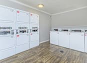 Thumbnail 20 of 22 - a laundry room with white washers and dryers