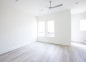 Thumbnail 9 of 26 - an empty room with white walls and a white ceiling fan