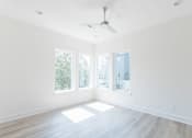 Thumbnail 19 of 26 - an empty room with three windows and a ceiling fan