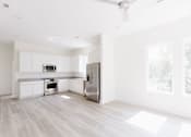 Thumbnail 10 of 26 - a kitchen with white cabinets and a stainless steel refrigerator