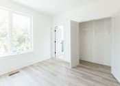 Thumbnail 20 of 26 - an empty room with a large window and white walls