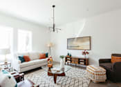 Thumbnail 3 of 26 - a living room with white walls and a white couch
