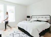 Thumbnail 16 of 26 - a bedroom with a bed and a window