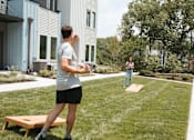 Thumbnail 24 of 26 - a man and a woman playing frisbee on a lawn