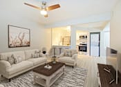 Thumbnail 1 of 28 - A living room with a white couch and a coffee table.