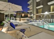 Thumbnail 11 of 17 - Pool with lounge deck and chairs at night