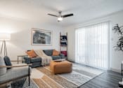 Thumbnail 3 of 20 - our apartments offer a living room with a couch and a ceiling fan