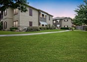 Thumbnail 25 of 28 - an image of an apartment complex with a green lawn