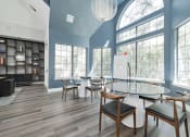Thumbnail 14 of 20 - a dining room with a table and chairs and large windows