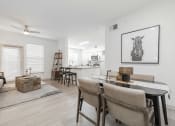 Thumbnail 6 of 35 - a living room and dining room with a table and chairs