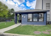 Thumbnail 24 of 26 - a small blue building with a bench in the background