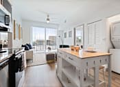 Thumbnail 2 of 34 - A kitchen with a table and chairs in the middle of the room.