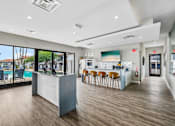 Thumbnail 16 of 26 - A modern kitchen with a bar area and wooden flooring.