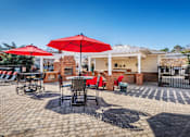Thumbnail 23 of 29 - a patio with tables and chairs and umbrellas