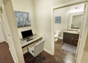 Thumbnail 30 of 35 - A room with a desk and a chair.