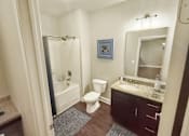Thumbnail 31 of 35 - A bathroom with a toilet, sink, and shower.