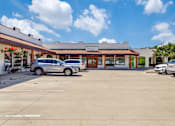 Thumbnail 48 of 62 - a parking lot in front of a restaurant with cars parked
