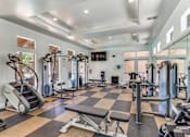 Thumbnail 14 of 62 - a gym with weights and cardio equipment and glass walls