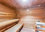 Thumbnail 27 of 62 - a sauna with wooden benches and a table
