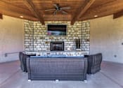 Thumbnail 23 of 62 - a patio with a fireplace and a table and chairs