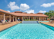Thumbnail 18 of 62 - a swimming pool with a house in the background