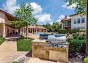 Thumbnail 26 of 62 - a barbecue grill in the backyard of a house with a swimming pool